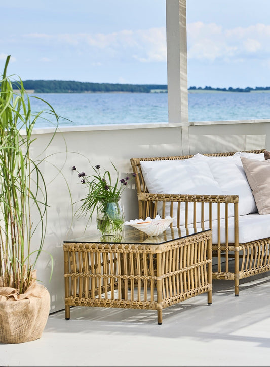 Utebordet Caroline Side Table fra Sika Design matcher resten av Caroline-serien perfekt. Et elegant og 'luftig' bord til uterommet! Rammen er laget i Alu-Rattan, pulverlakkert aluminium som ligner på rotting i både form og farge og dette gjør Caroline-serien til en sofistikert og innbydende utemøbelkolleksjon som tåler vær og vind. Velg mellom tre ulike farger på rammen: Naturfarget, mørkere brun eller hvit. Bordplaten er laget av herdet glass.