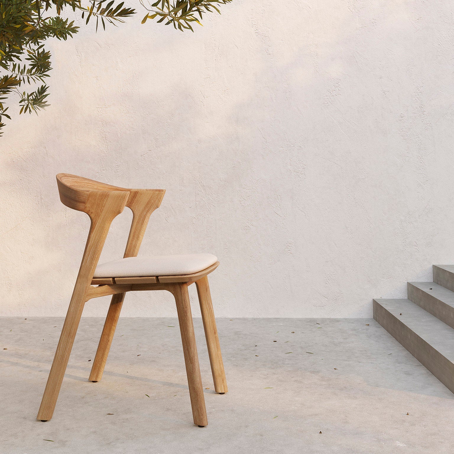 Spisestolen Bok Outdoor Dining Chair fra Ethnicraft har en grasiøs silhuett der kantene er mykt avrundede og den buede ryggen lar deg sitte bekvemt over tid.