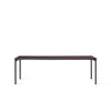 Bord Co Table Terra 100x240 cm fra Audo Copenhagen med kullfarget bordplate i laminat med sorte ben og detaljer i mørk eik.