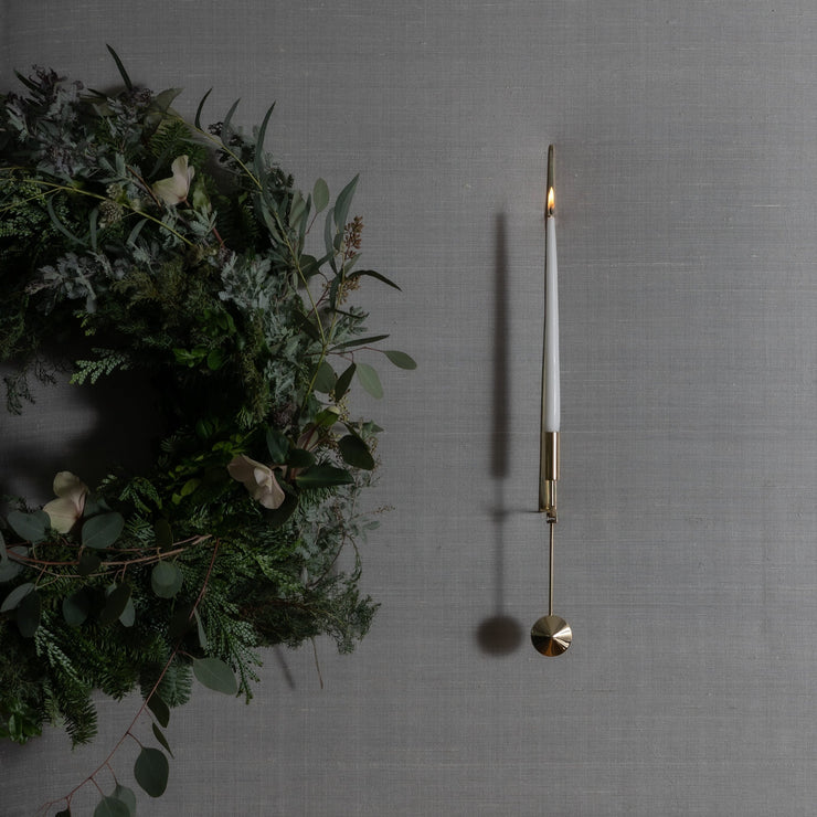 Den elegante vegglysestaken Pendel Sconce i blankpolert messing fra Skultuna – med sin ikoniske smale design – ble designet av sølvsmeden og designeren Pierre Forssell på slutten av 1950-tallet. Denne blir som et vakkert smykke på veggen, enten du har den hengende i en gang, på et kjøkken – eller i stuen.