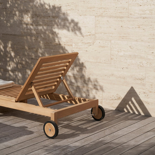 Solseng AH604 Outdoor Lounger fra Carl Hansen & Søn har høy komfort med justerbar rygg, og er utstyrt med to hjul bak, noe som gjør den enkel å flytte etter solen eller inn i skyggen. 
