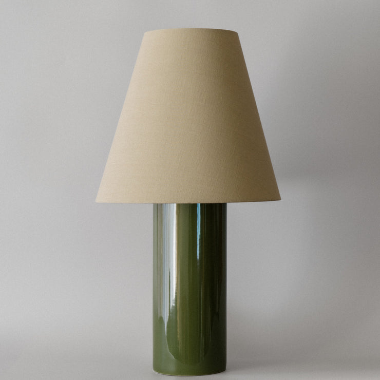 Bordlampen Giro Treetop & Beige har en keramisk sylinderformet lampefot med en skogsgrønn glasur og en konisk skjerm drapert i en teksturert lys beige bomull (fra Haider Ackermann) som sprer et behagelig og stemningsfullt varmt lys. En raffinert bordlampe som vil tilføre ethvert rom en dose sofistikert eleganse!