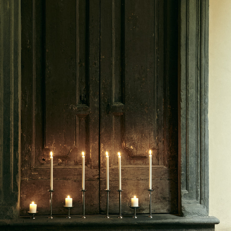 Den vakre lysestaken Champagne Candle Holder i polert rustfritt stål fra Louise Roe er i toppsjiktet på vår favorittliste når det kommer til vakre, klassiske lysestaker. I tillegg til å ha en praktisk kant som fanger opp dryppende stearin er den høyreist, elegant og har et tidløst preg – rett og slett en lysestake som kan følge deg li