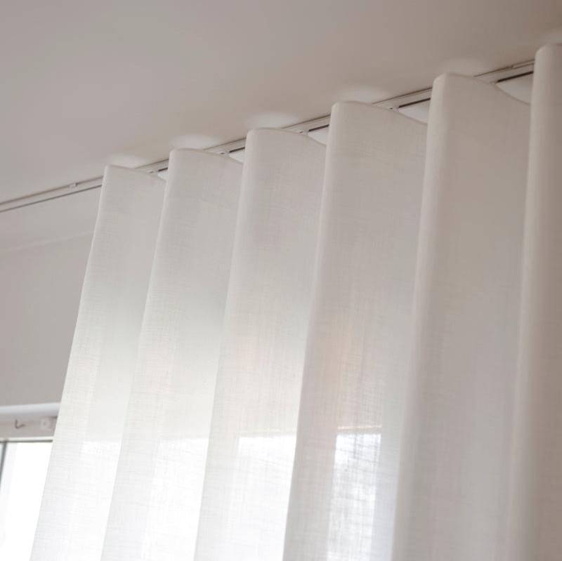 Wavegardin tynn lin Elegant i takskinne. Hvit gardin mot hvite vegger. 