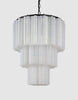 Lysekronen Fontaine Chandelier 3-layer fra norske Meublé smykker ethvert rom den henger i! Vi er spesielt begeistret for den med svart base og melkehvitt glass der de vakkert formede glassylinderne slipper lyset gjennom på en myk og delikat måte. Denne er perfekt for deg som er ute etter en moderne lysekrone som henger nydelig i en rosett, i stuen eller over et spisebord, i en større hall eller i et trappeløp – eller på soverommet!