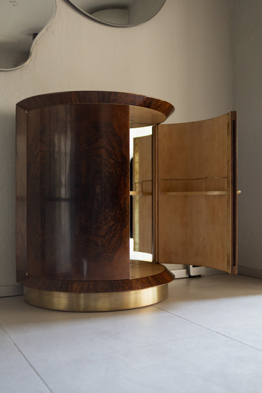 Vintage barskap i Art Deco-stil: Dette elegante halvsirkelformede barskapet er kledd med en akk-så-vakker og dekorativ høyglans rotfiner av valnøtt og hviler på en sokkel kledd i patinert messing.