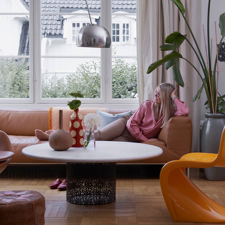 Inspirasjonen var hentet fra en gatelykt, og ambisjonen var å lage en taklampe som ikke måtte henge i taket. Lampeskjermen i krom henger 2 meter bort fra foten, noe som gjør at den både kan stå ved et stuebord og et spisebord.