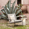 Utestol Desert Dolce Lounge Chair i Dark Sand / gråbeige med svart understell fra Ferm Living kommer også i 1-seter. Ved siden av bordet Mineral Sculpture i hvit marmor. 